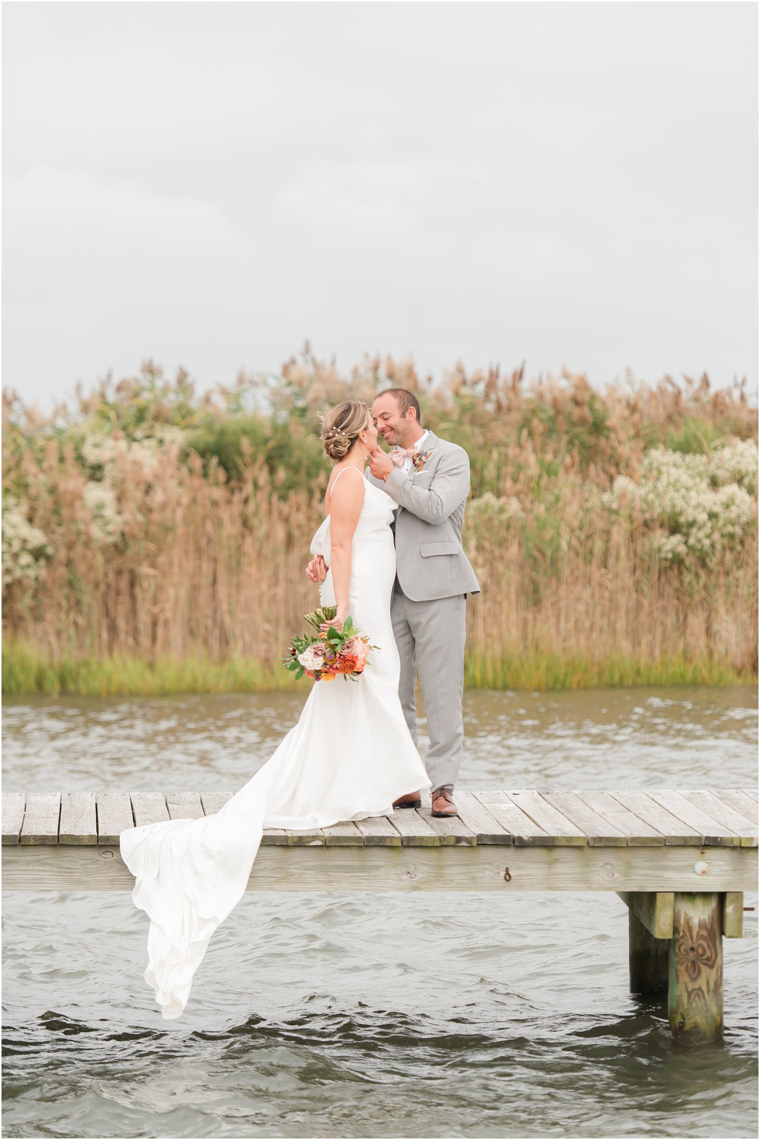 bride and groom stand on docks at Bonnet Island Estate