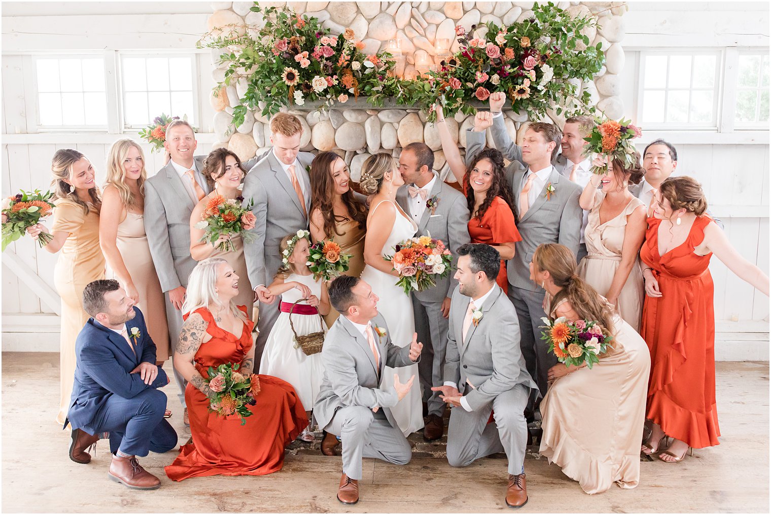 bride and groom kiss with wedding party around them at Bonnet Island Estate