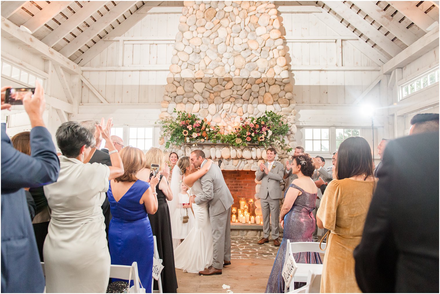 newlyweds kiss after fall wedding ceremony in Manahawkin NJ