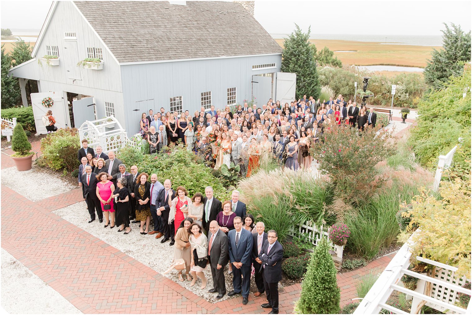 bride and groom pose with all wedding guests outside Bonnet Island Estate