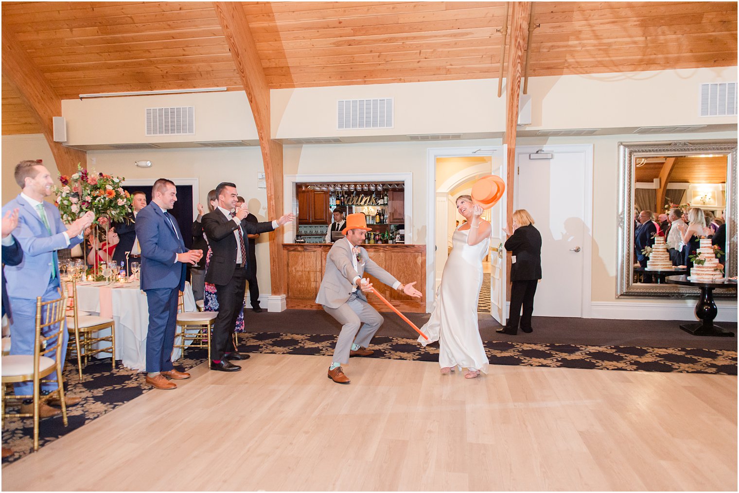 bride and groom enter wedding reception with top hats