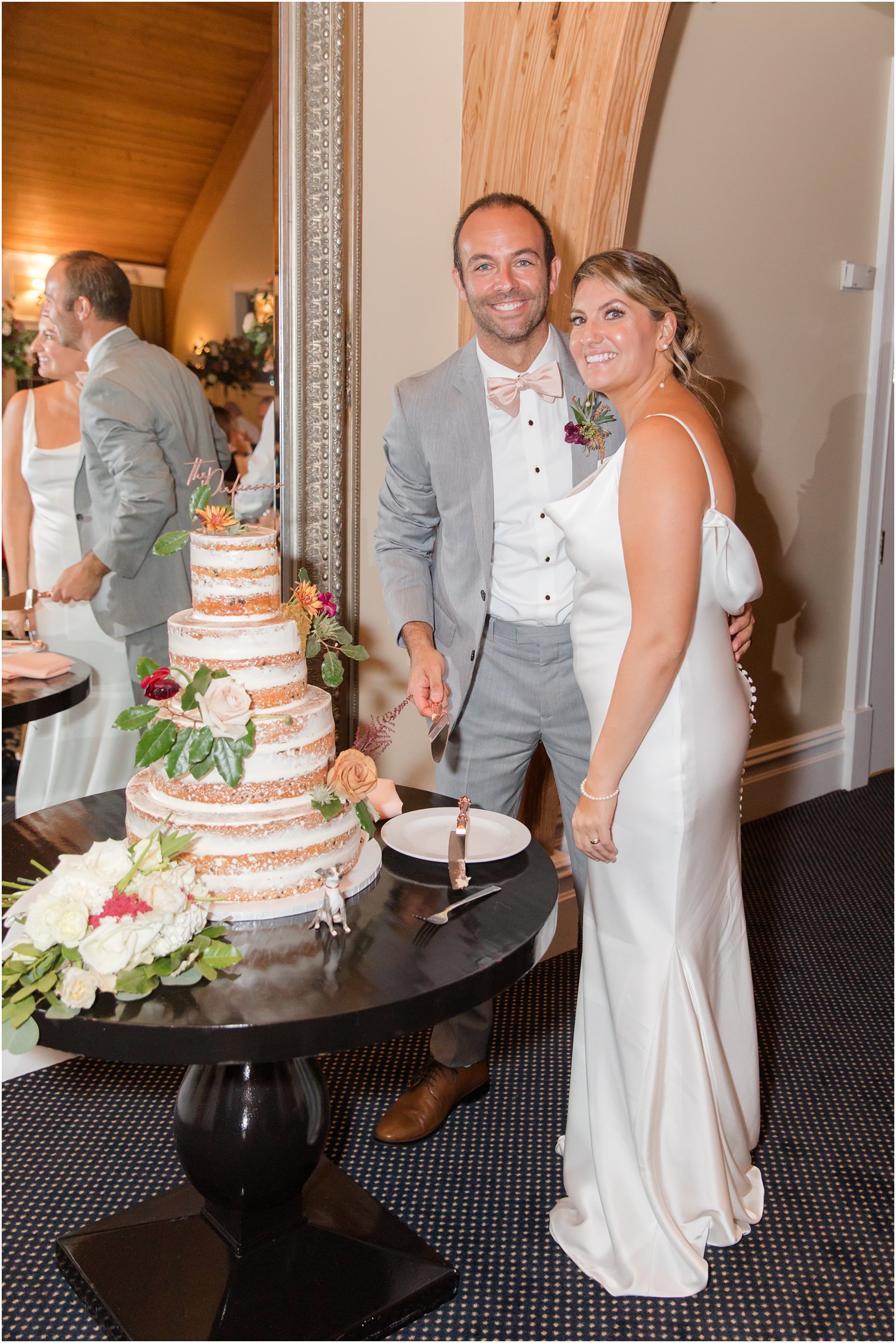 couple cuts wedding cake during Manahawkin NJ wedding reception 