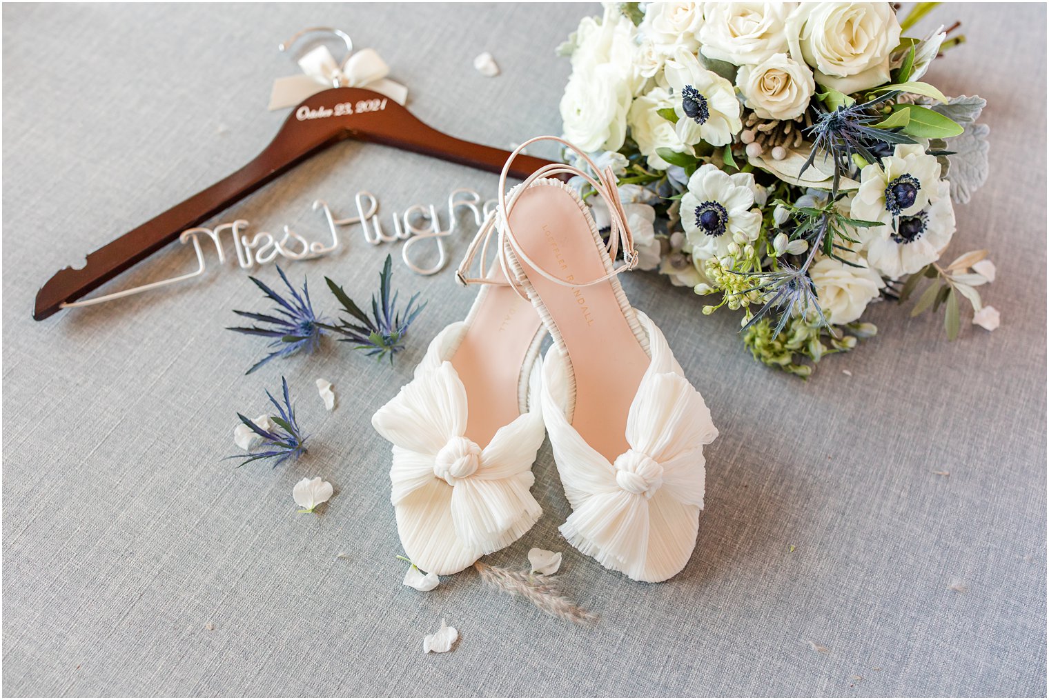 bride's white shoes and custom hanger for fall wedding day