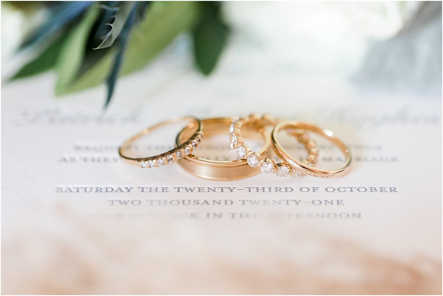 wedding bands rest on wedding invitation for fall wedding 