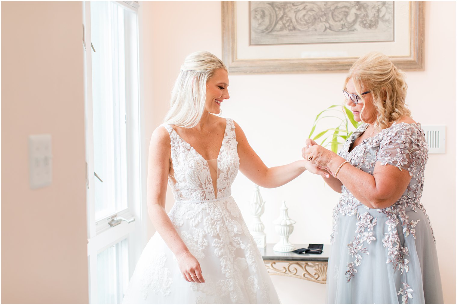 mother helps bride with bracelet on wedding morning in Brant Beach 