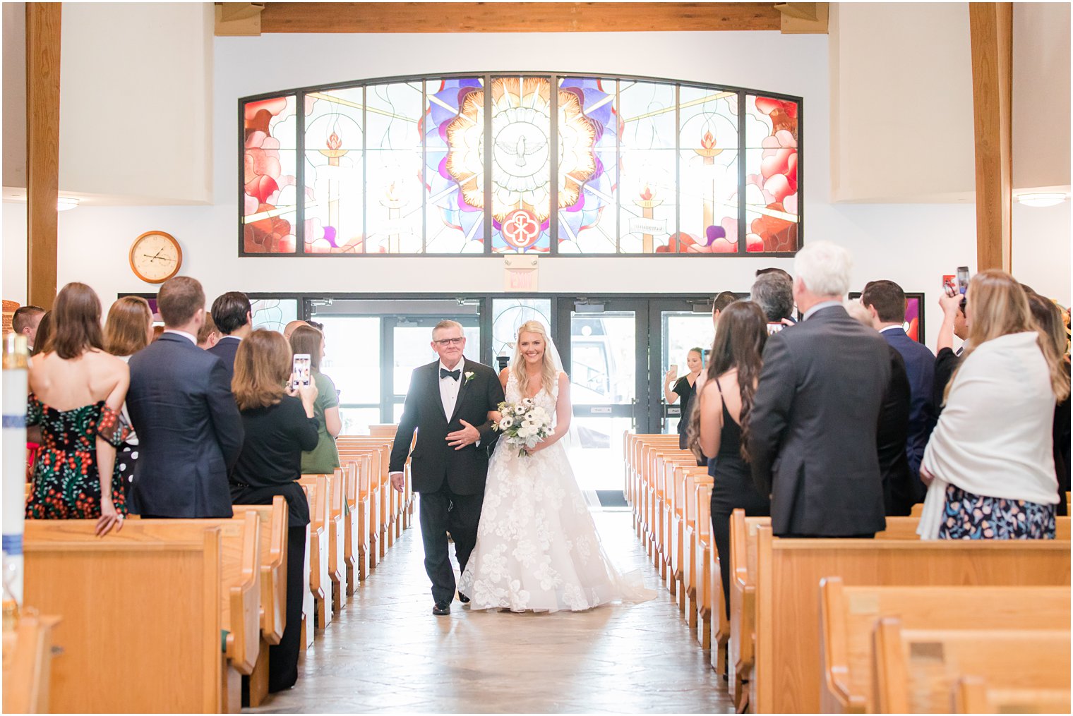 bride walks down aisle with dad for traditional church wedding in New Jersey