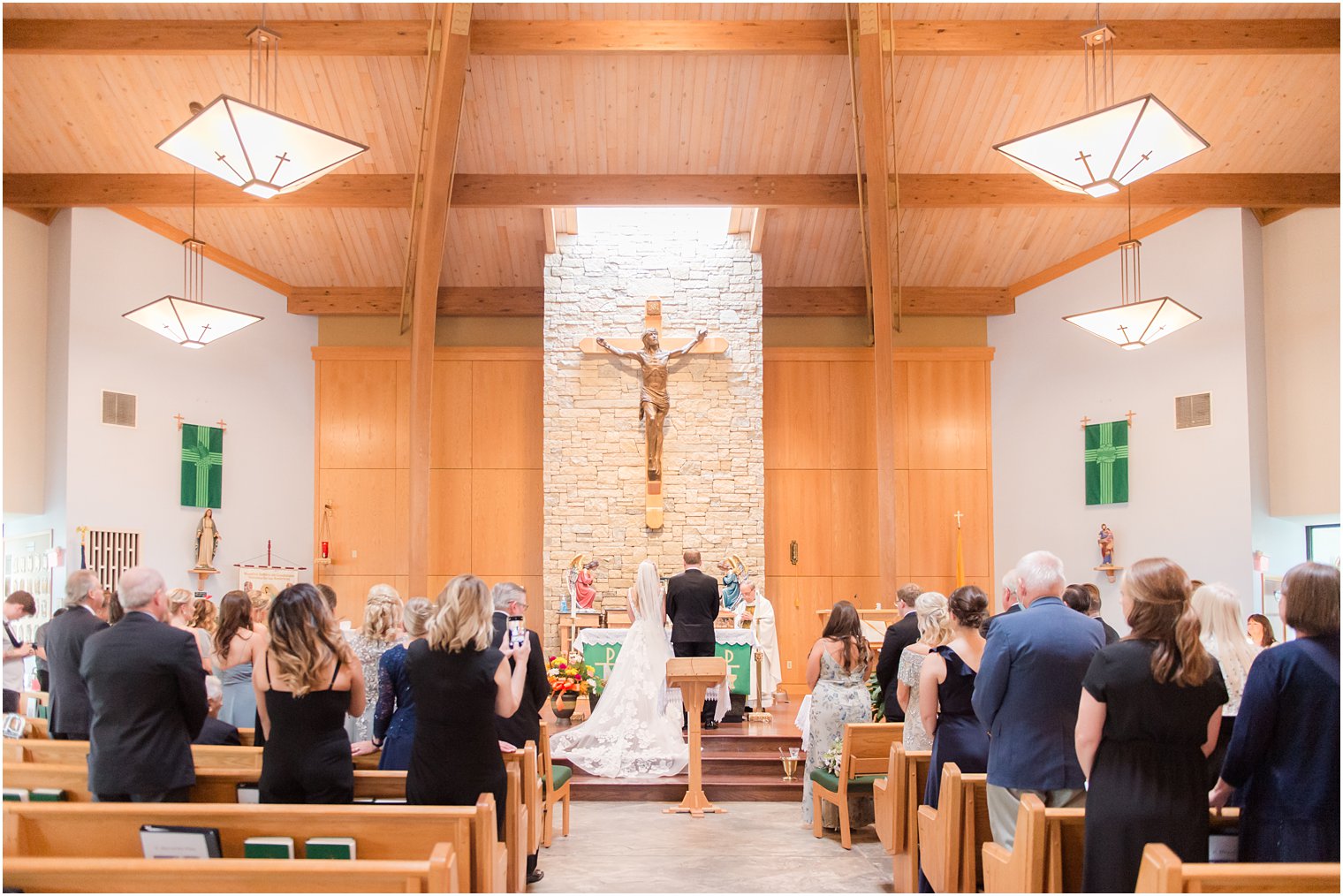 bride and groom stand at altar during traditional church wedding in New Jersey