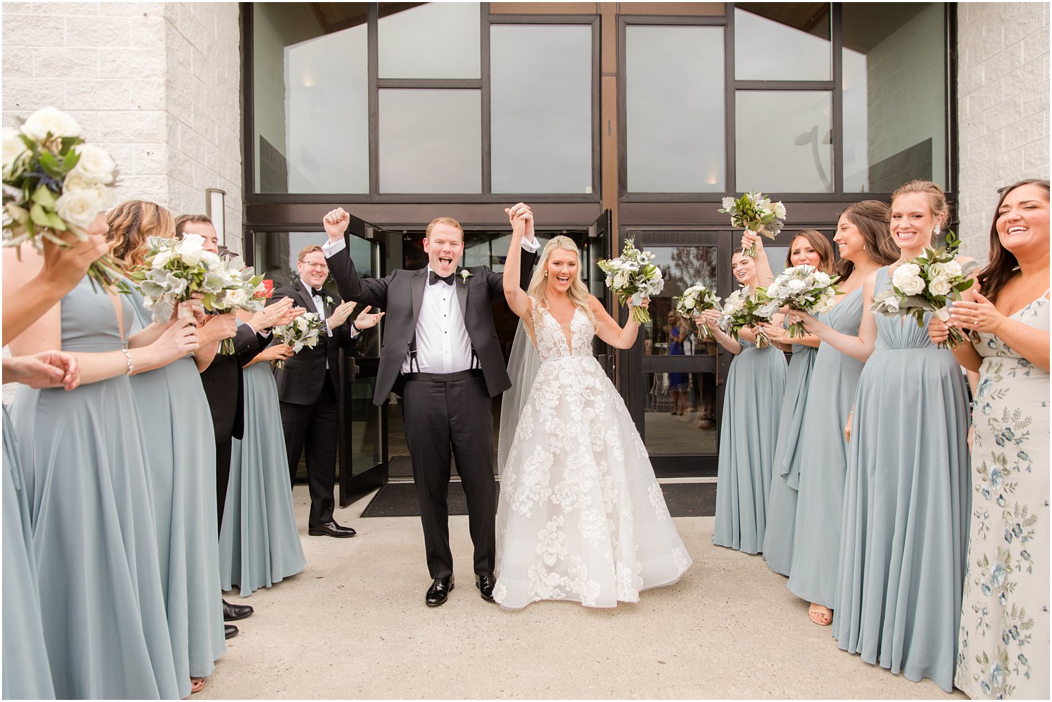 bride and groom cheer after church wedding in New Jersey 
