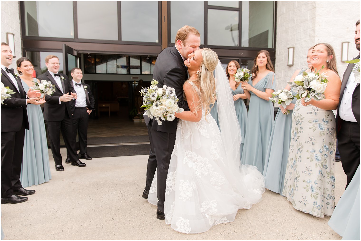 groom kisses bride's cheek during church exit in New Jersey 