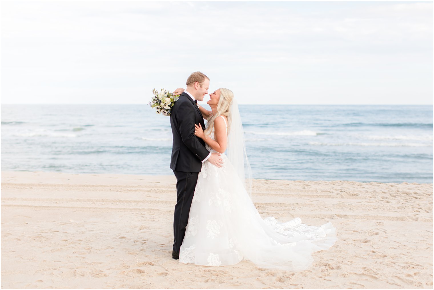 bride laughs at groom with noses touching during Brant Beach Yacht Club wedding day 