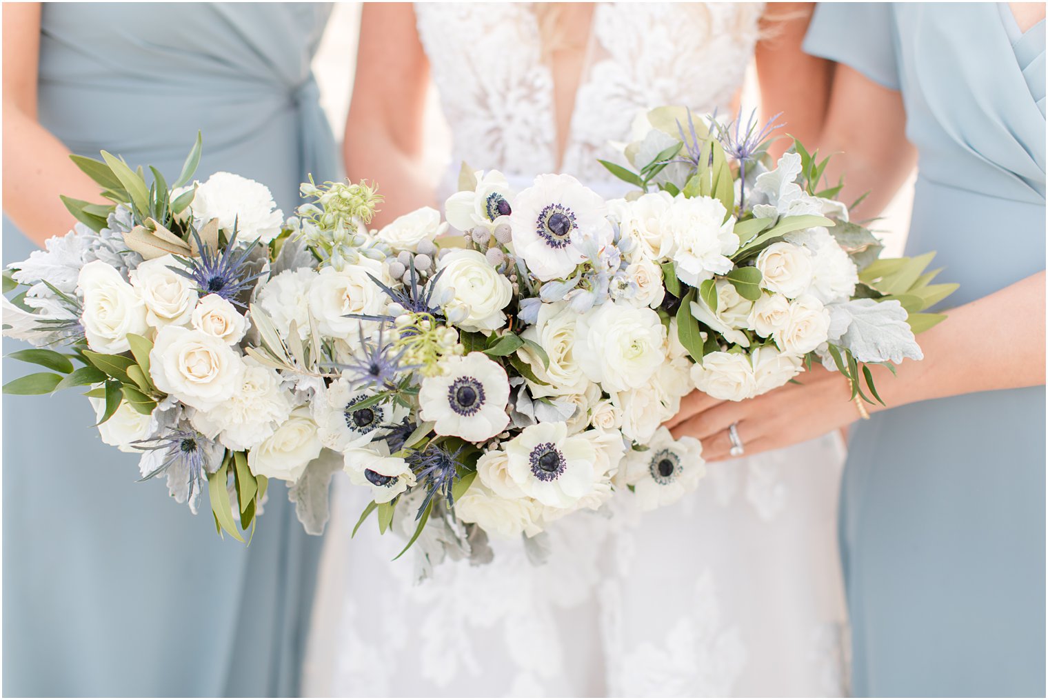 bride and bridesmaids hold bouquets of white and blue flowers at Brant Beach Yacht Club