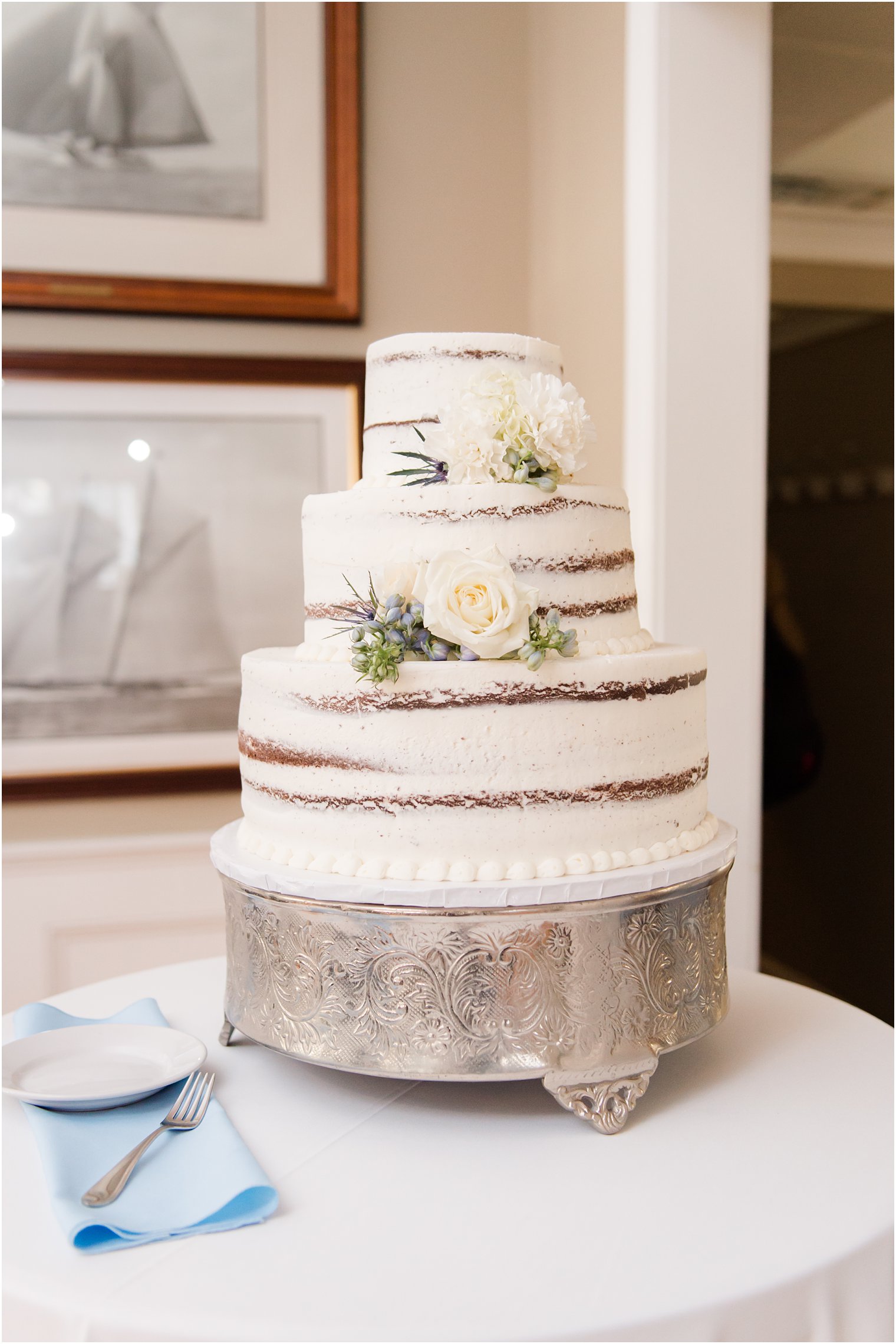 tiered naked wedding cake with floral accents at Brant Beach Yacht Club