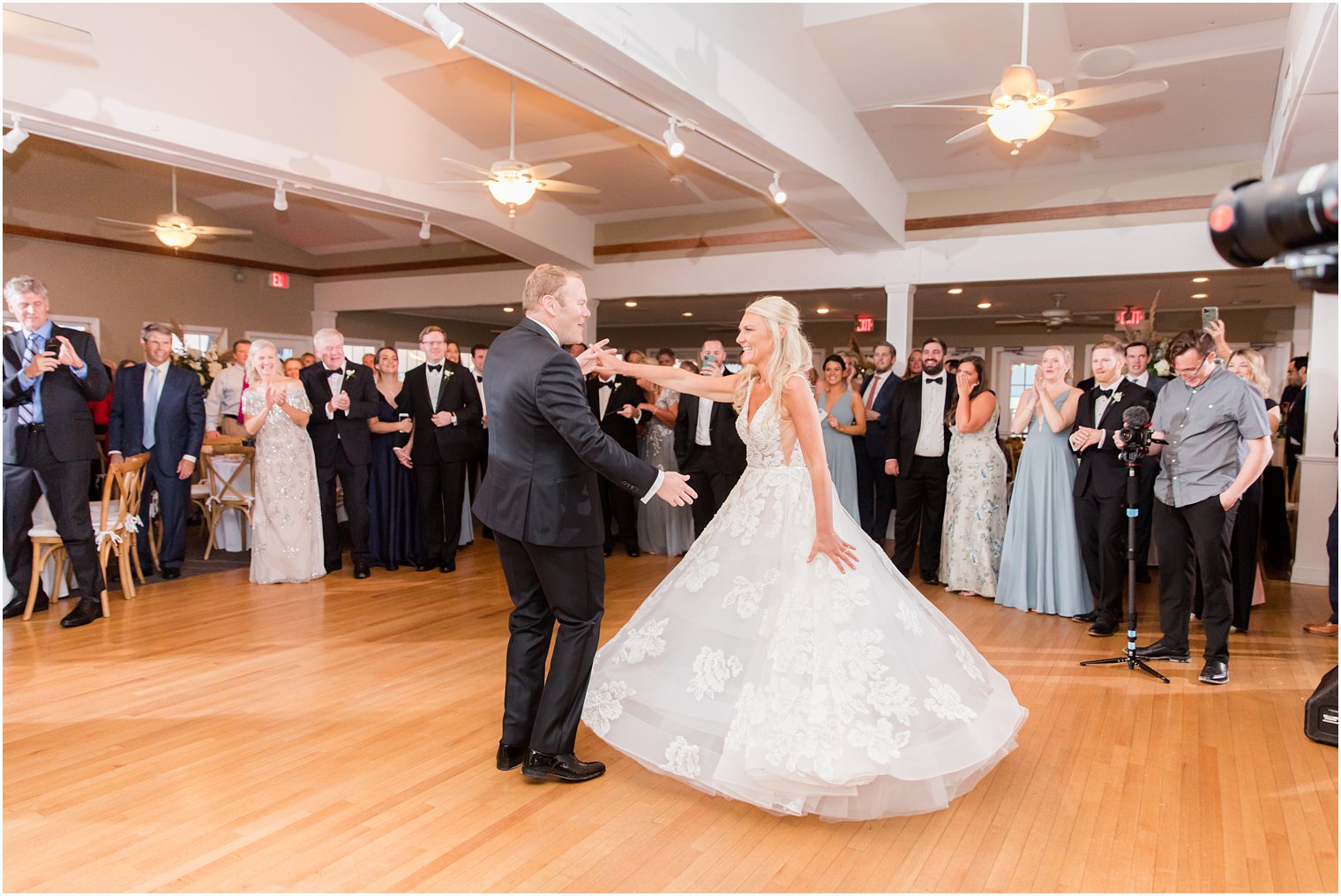 groom twirls bride during first dance at Brant Beach Yacht Club