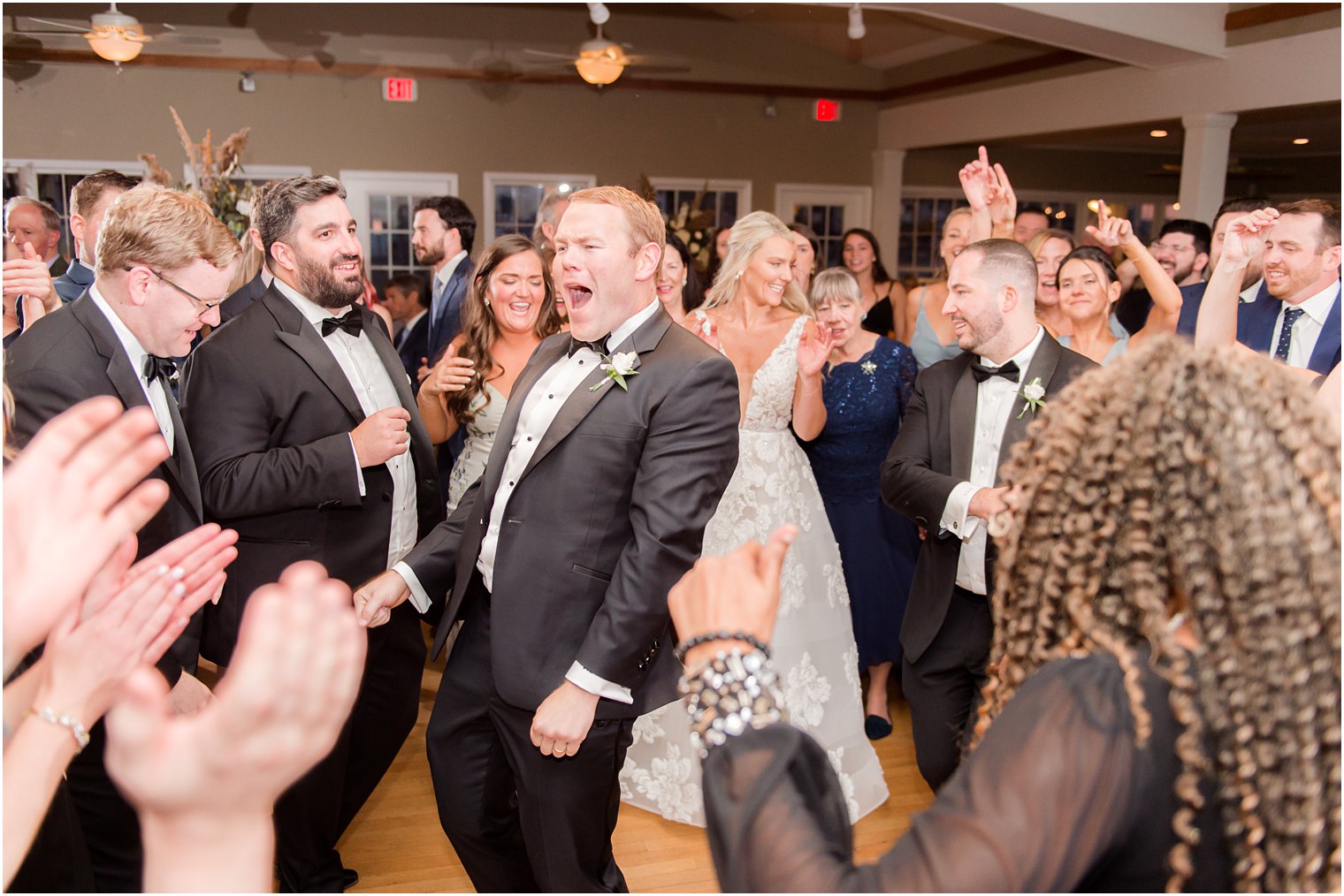 groom sings and dances during Long Beach NJ wedding reception 