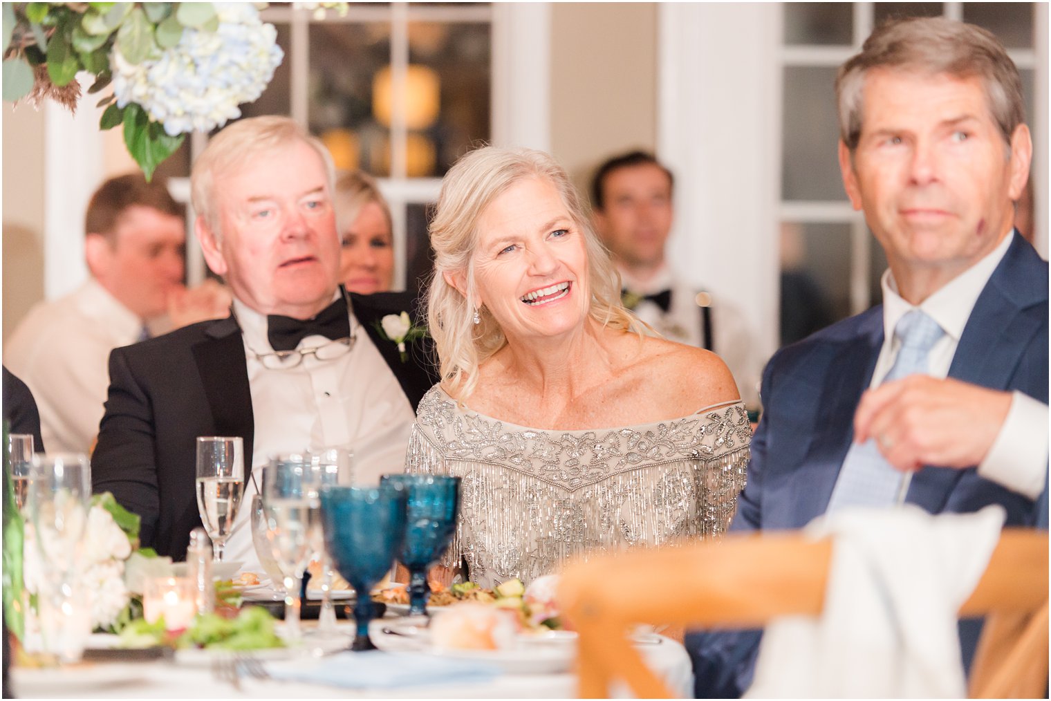 mother of the bride laughs during speech at Long Beach NJ wedding reception 