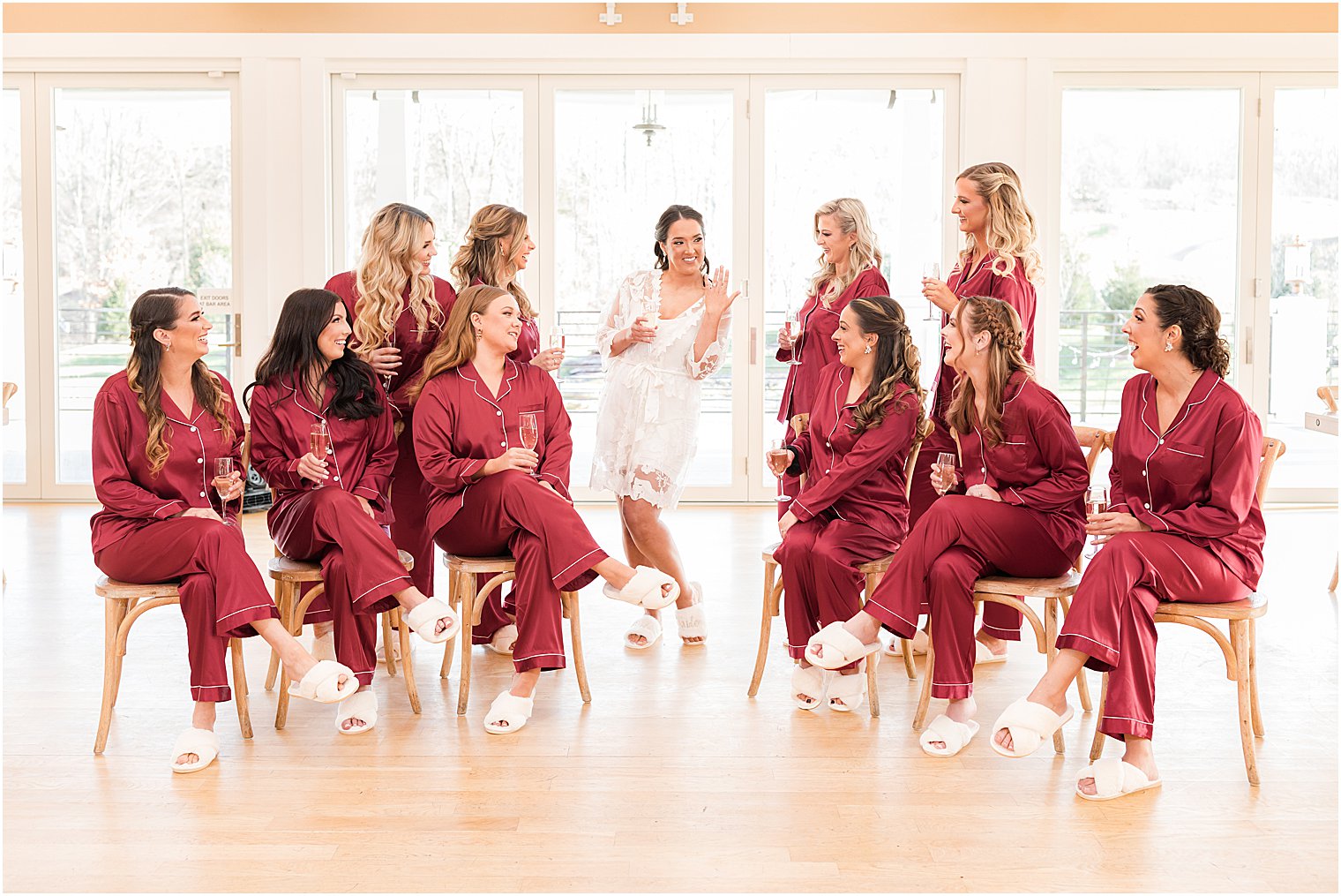 bridesmaids smile at bride showing off ring during NJ wedding prep