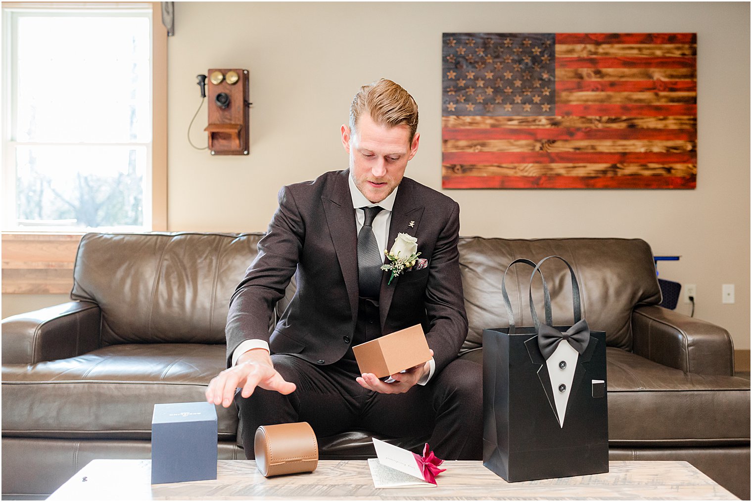 groom opens gift from bride on wedding day