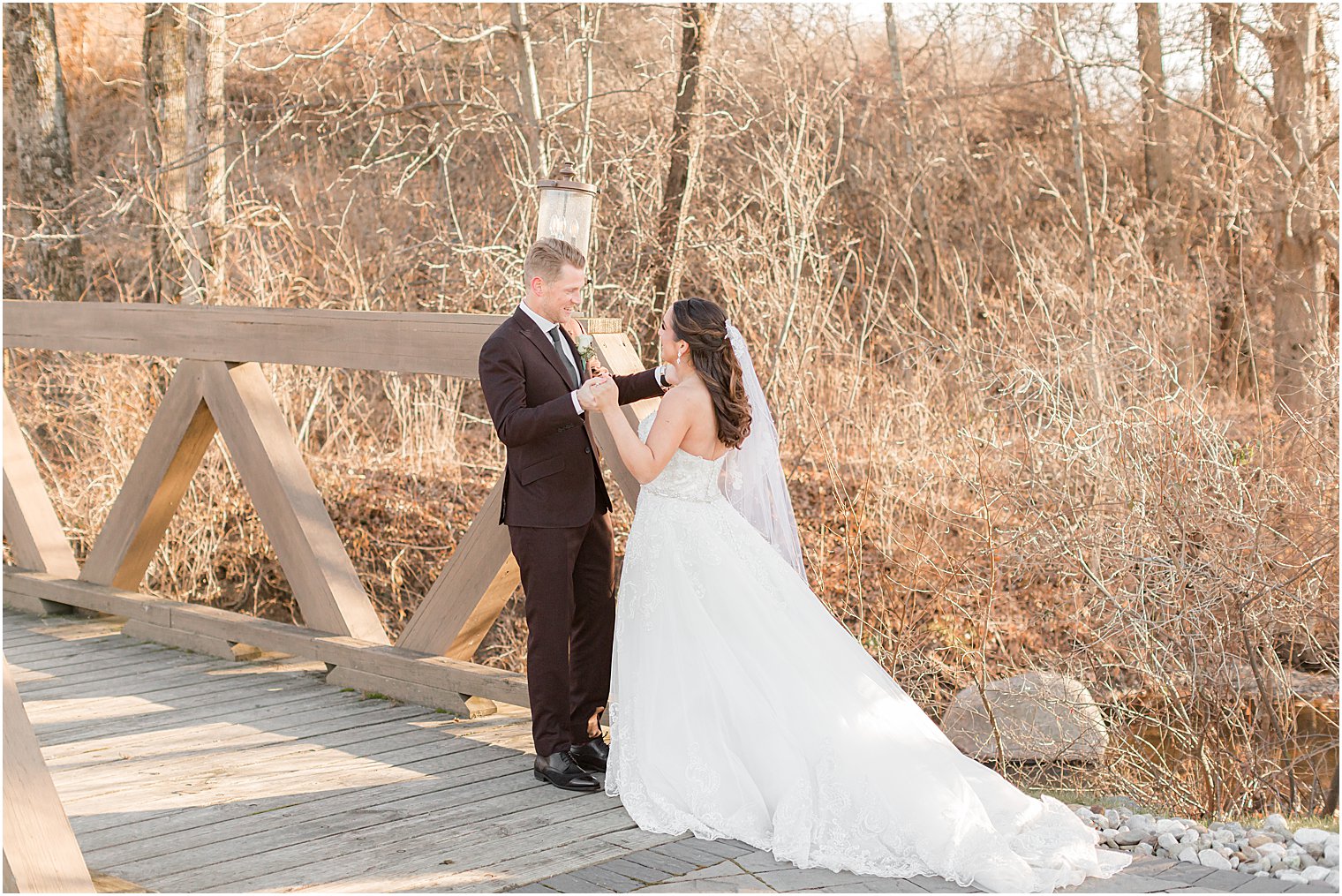 couple meets on bridge during winter wedding day first look
