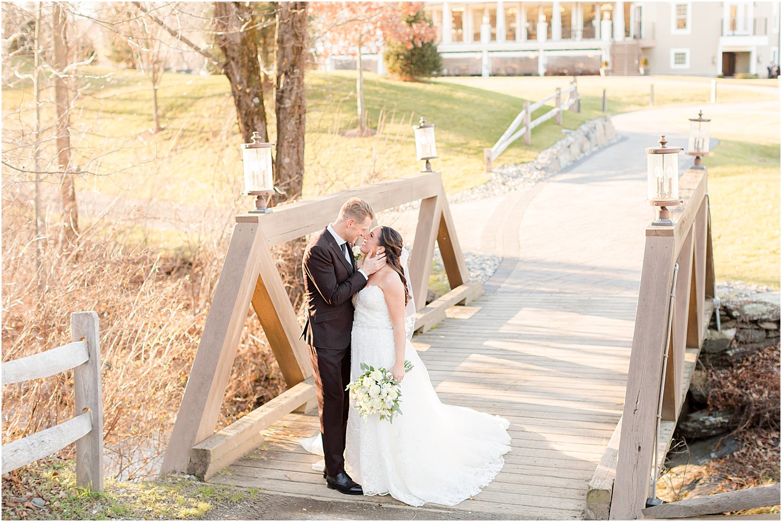 couple kisses on wooden bridge in northwest NJ