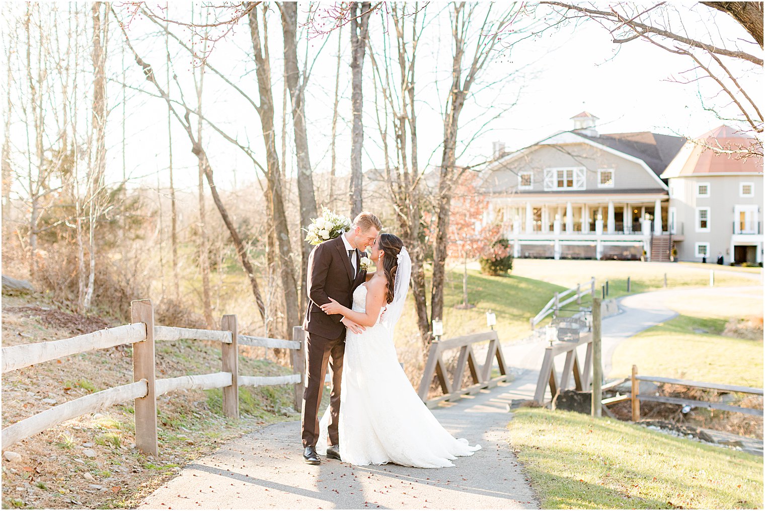 newlyweds kiss during winter wedding portraits in New Jersey