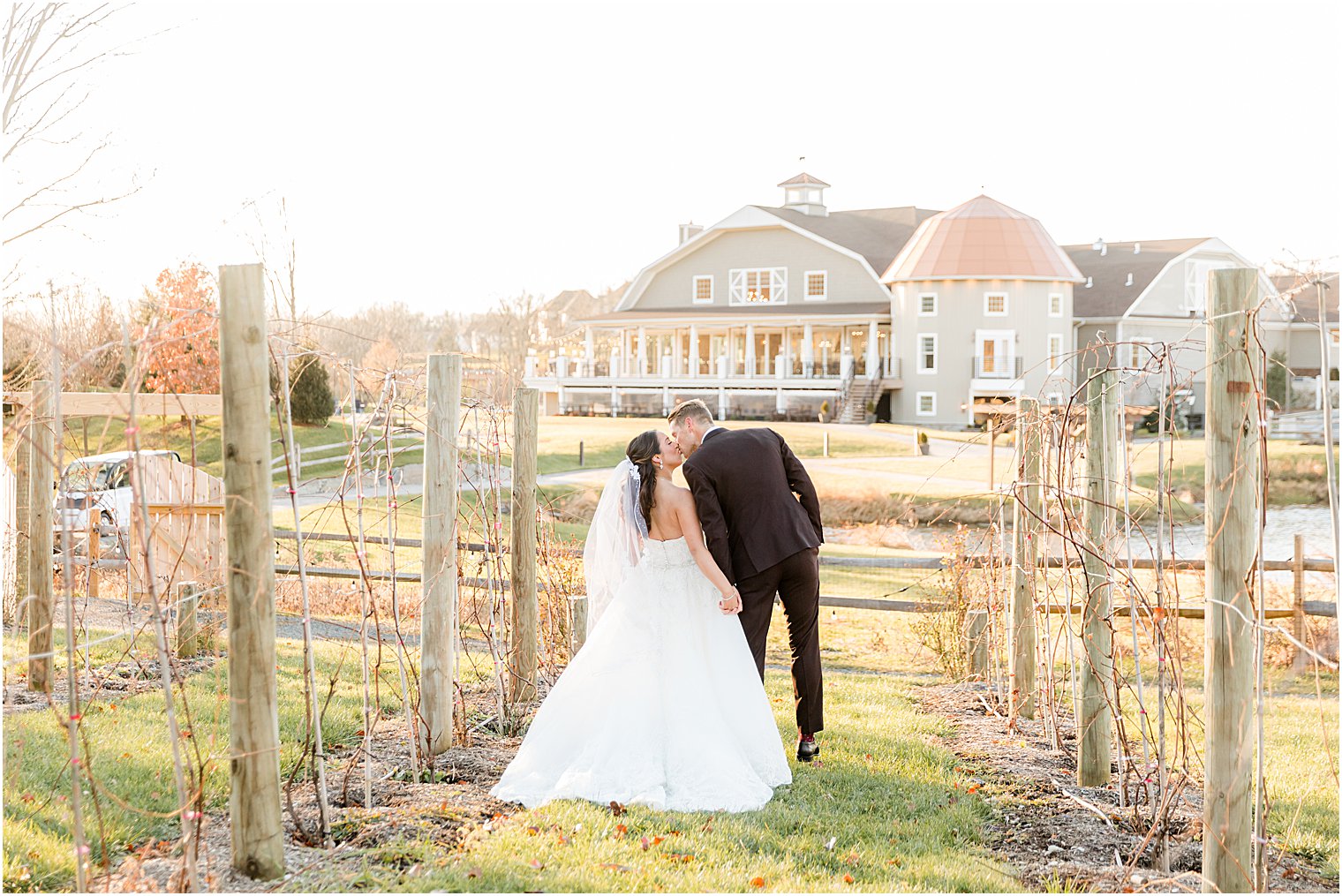 bride and groom walk towards Bear Brook Valley and kiss