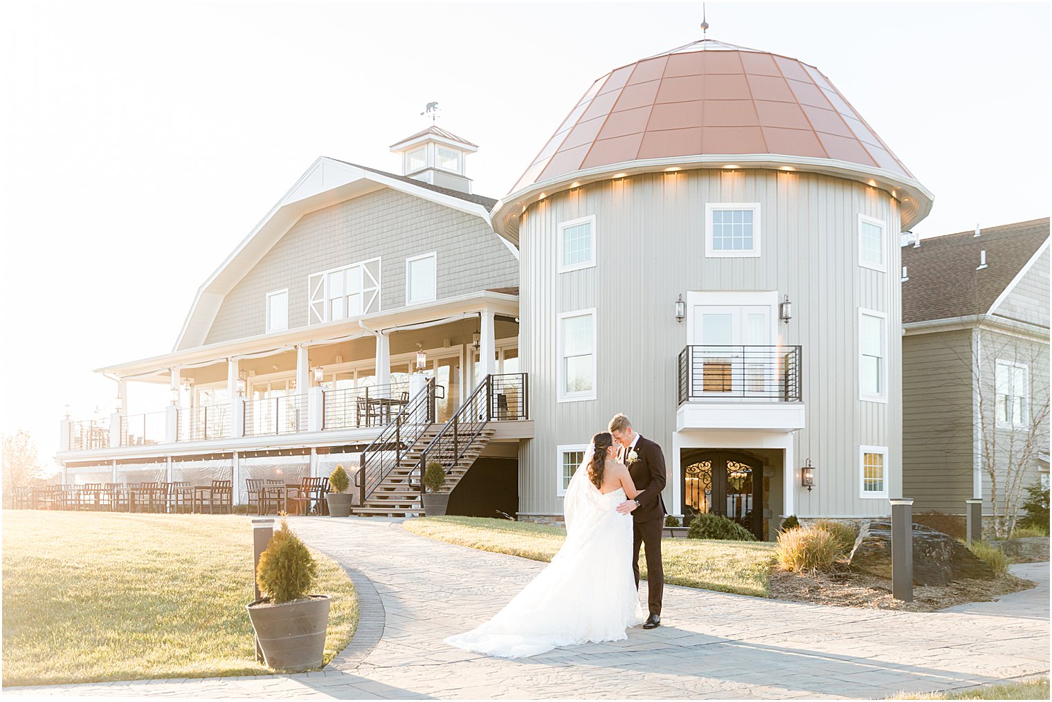 married couple kisses outside patio at Bear Brook Valley