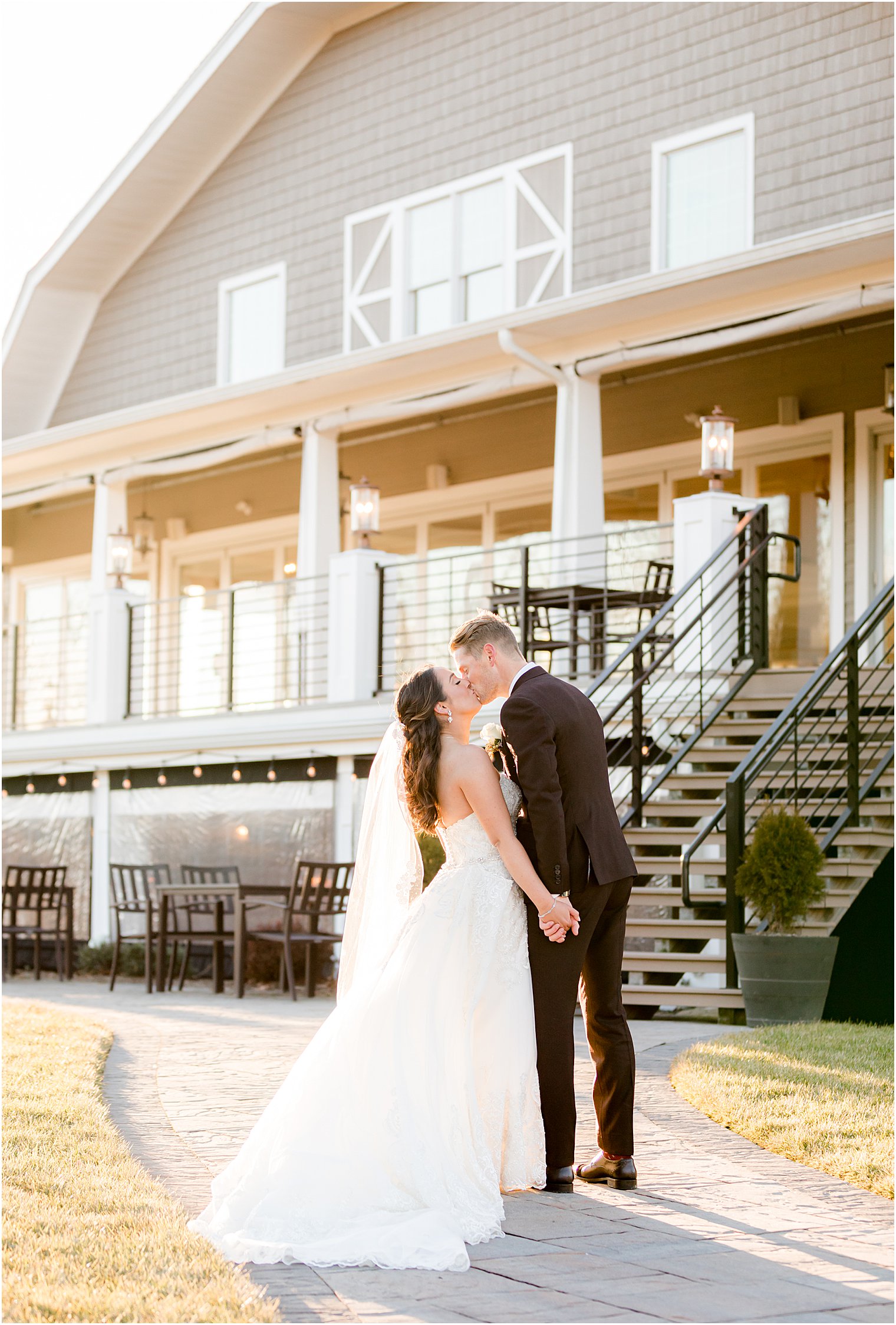 bride and groom kiss outside farmhouse in New Jersey