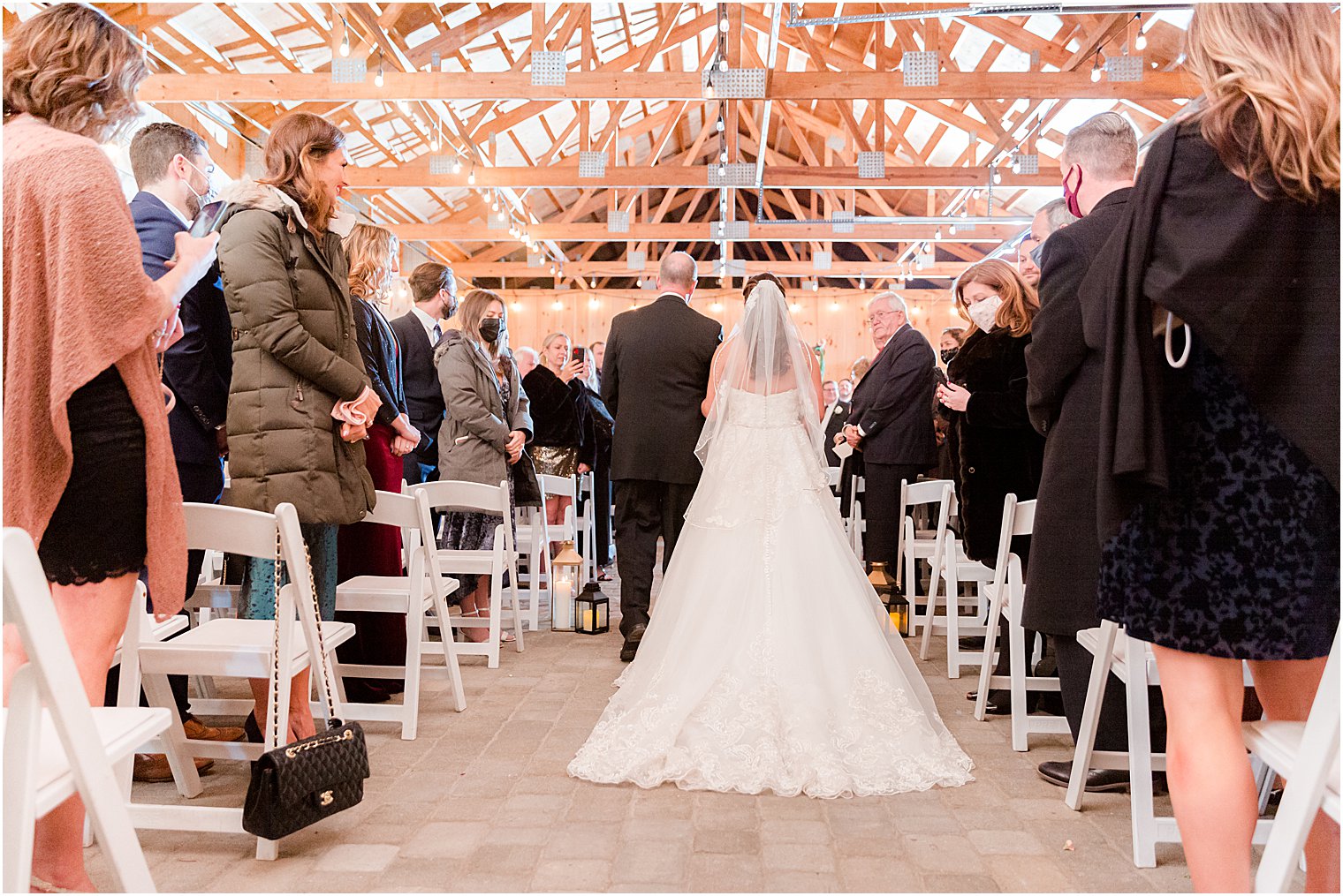 bride walk up aisle with father during NJ wedding ceremony in farmhouse