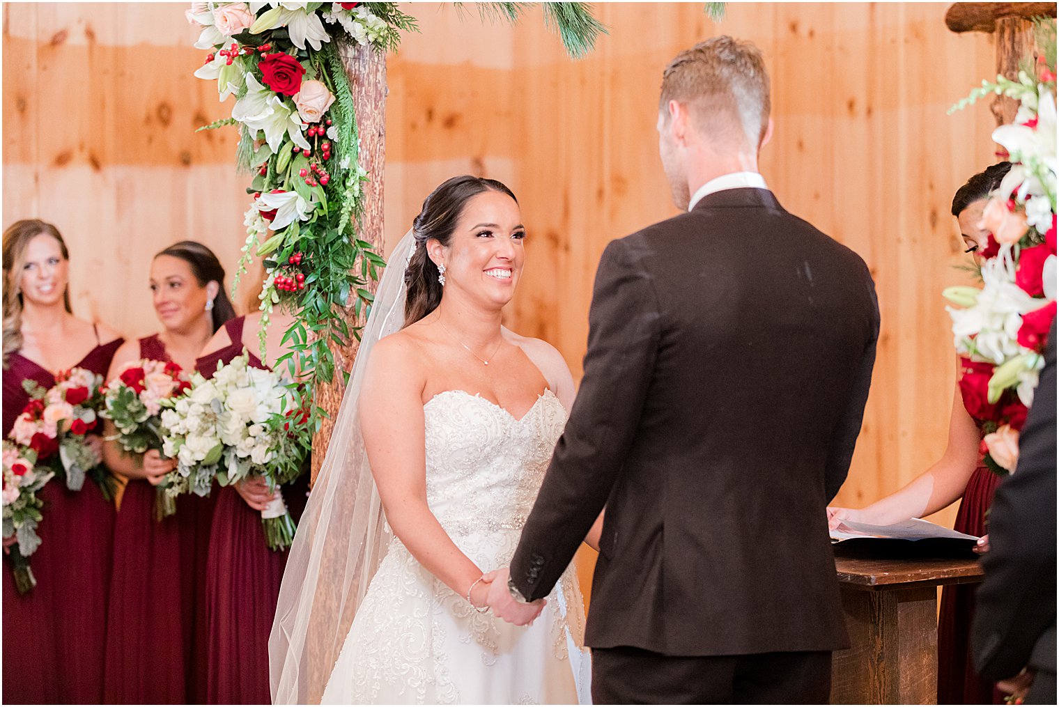 newlyweds exchange vows during wedding ceremony in farmhouse