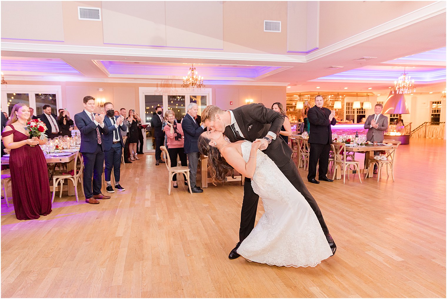 groom kisses bride during NJ wedding reception