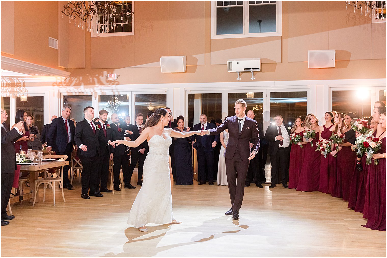 groom twirls bride out on dance floor