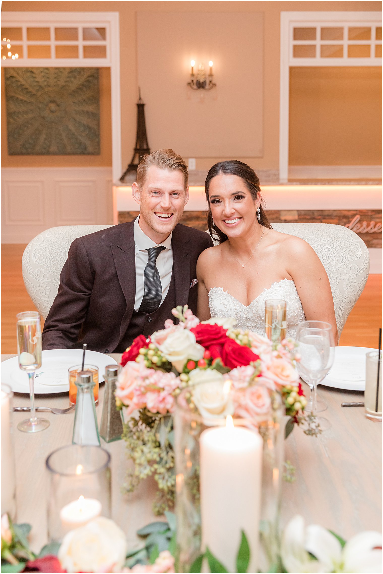 bride and groom sit at sweetheart table during NJ wedding reception