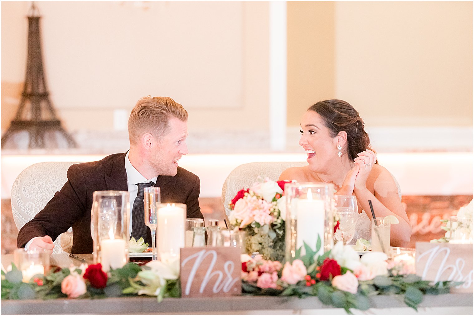 couple laughs together at sweetheart table during NJ wedding reception