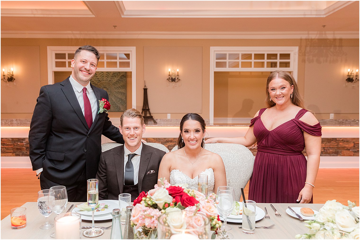 bride and groom pose with maid of honor and best man 