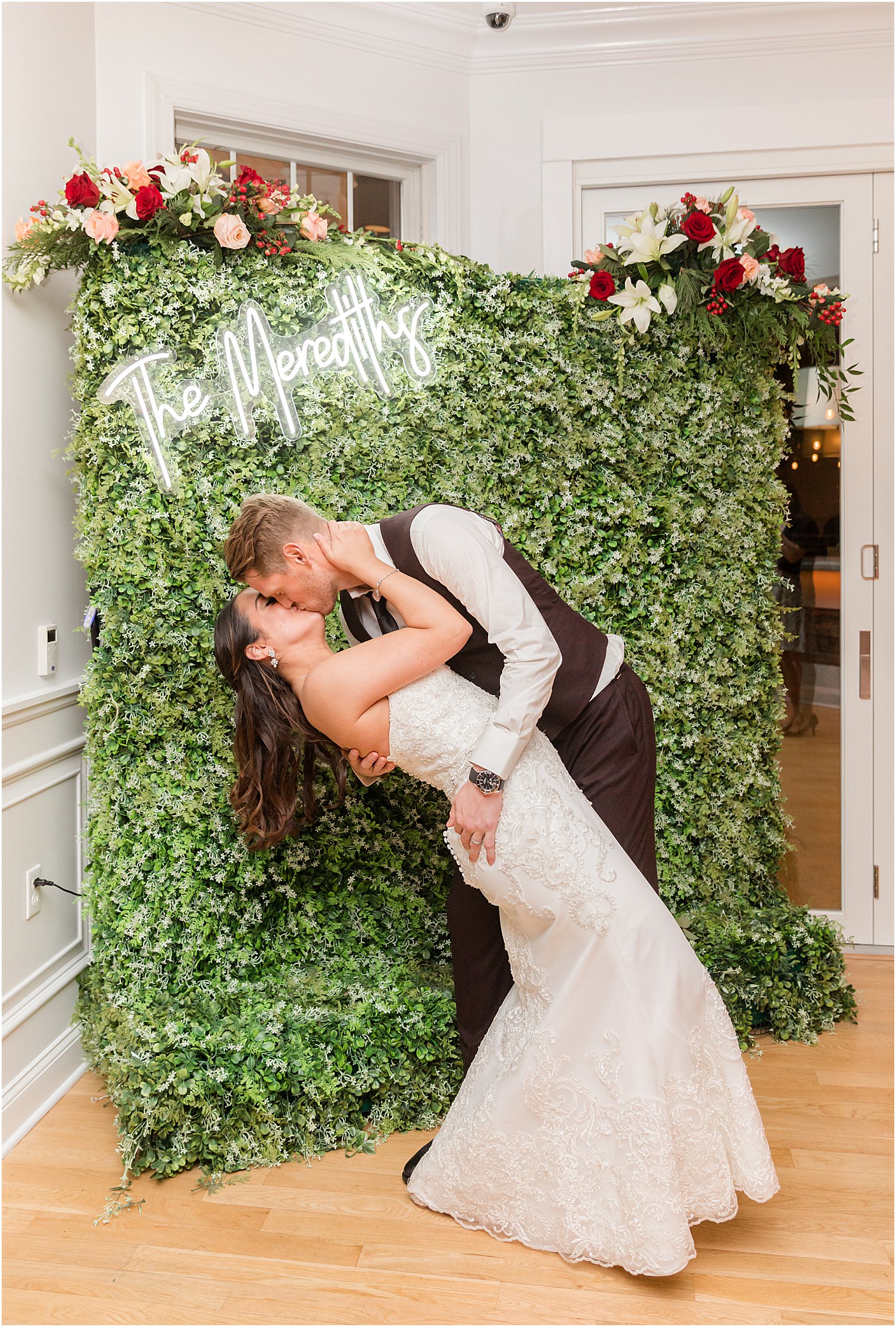 groom dips bride by phootbooth at Bear Brook Valley 