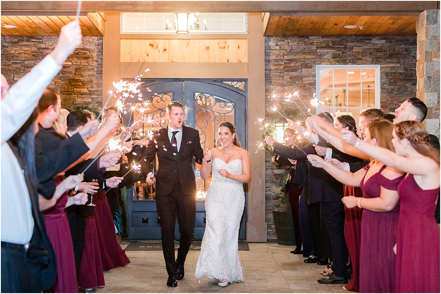bride and groom walk out of sparkler exit at Bear Brook Valley