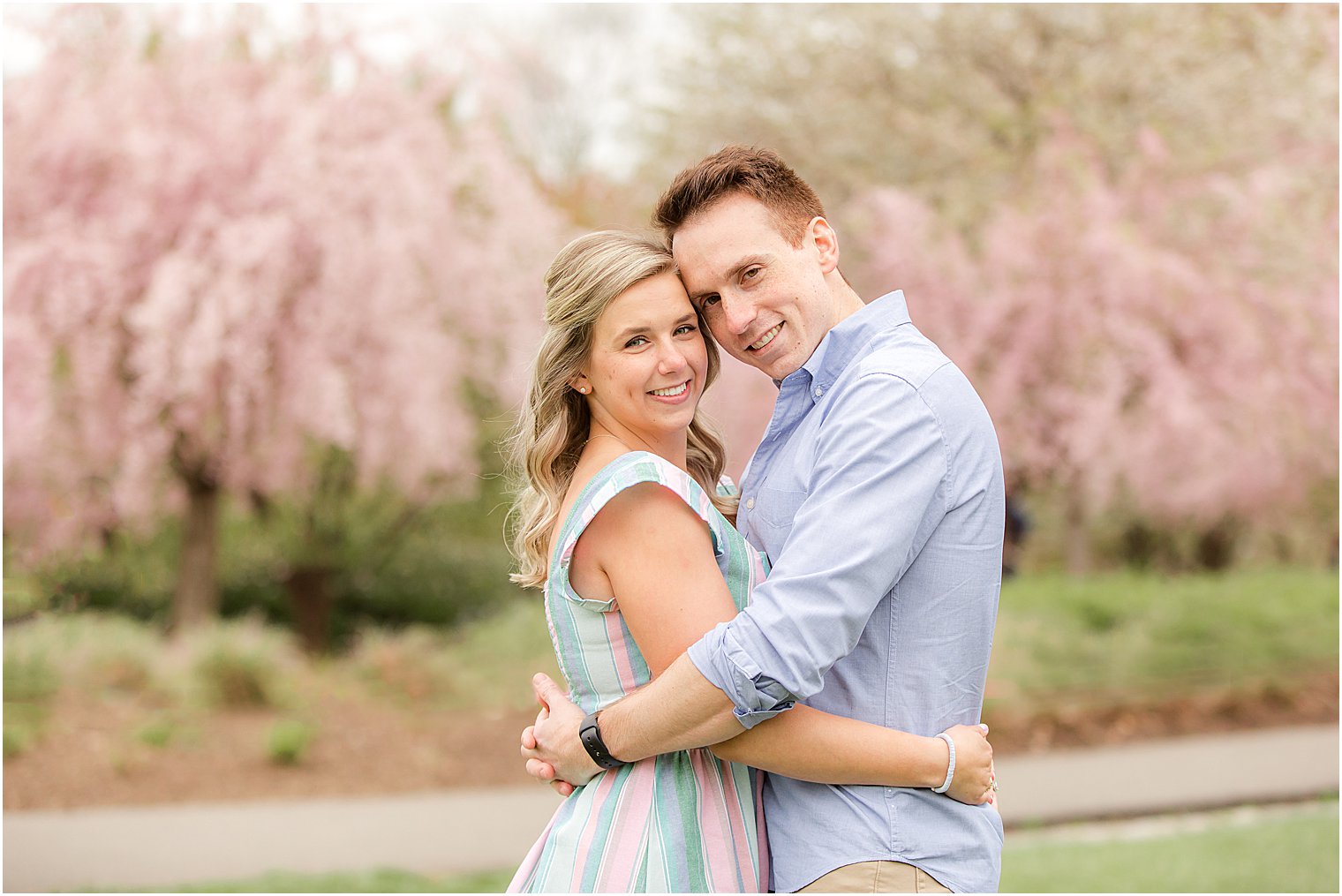 couple hugs during engagement session at Branch Brook Park