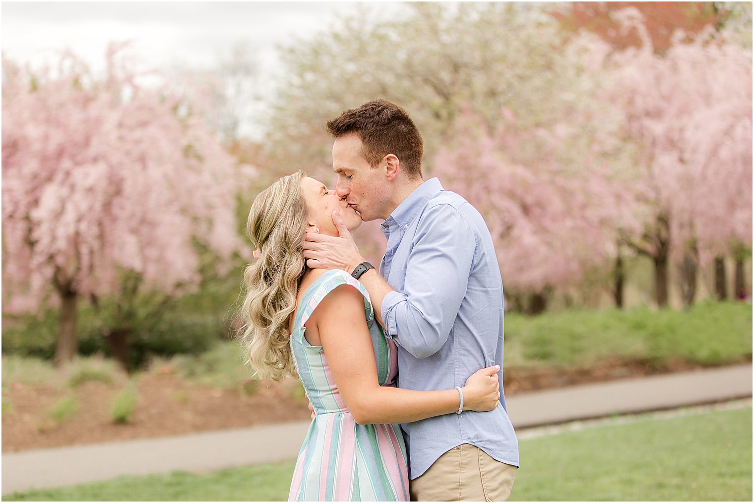 bride and groom kiss during engagement portraits at Branch Brook Park