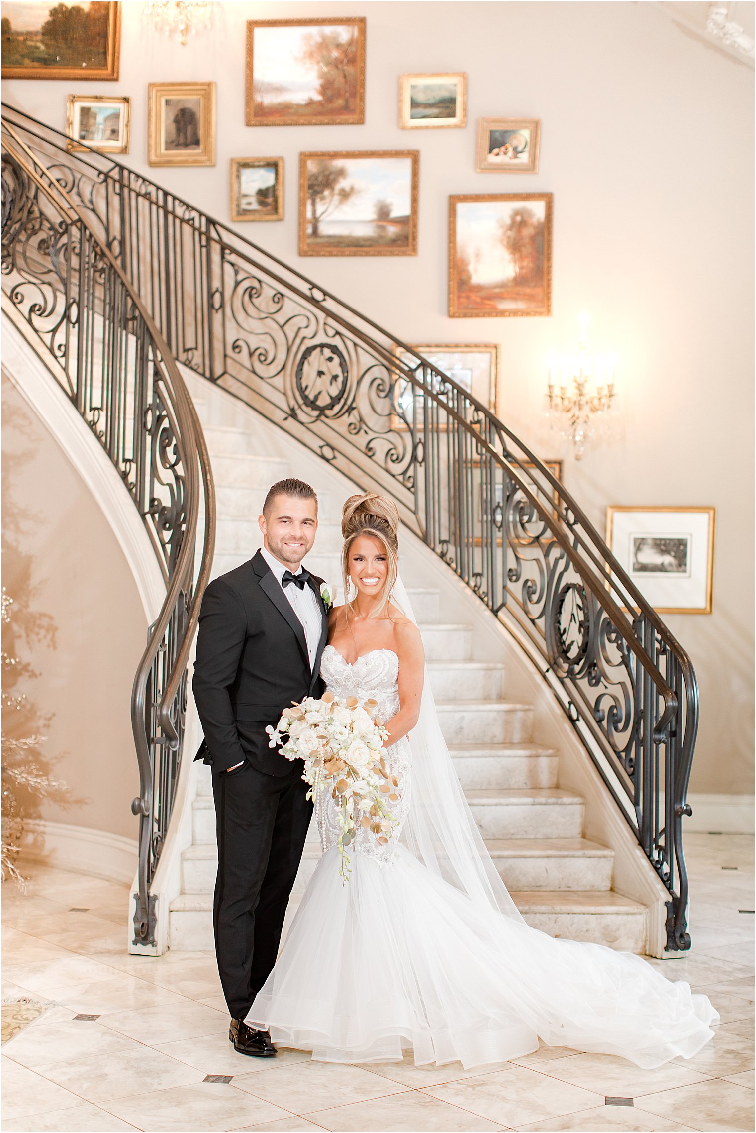 bride and groom hug at bottom of staircase in Park Chateau Estate 