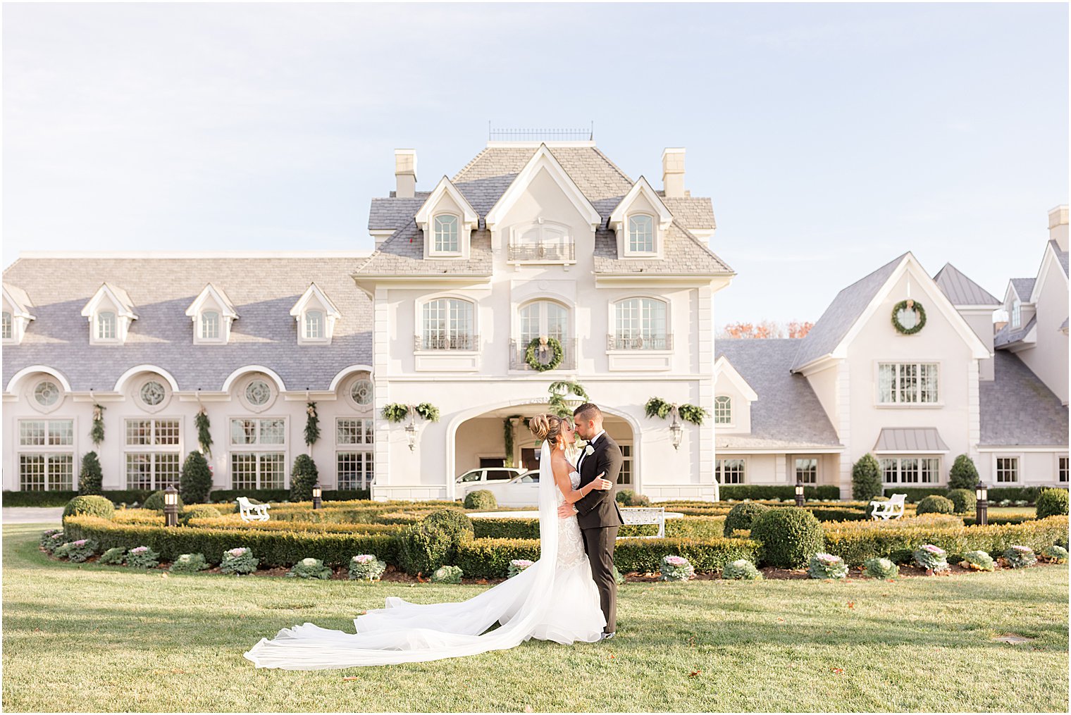 newlyweds kiss near fountain of Park Chateau Estate 