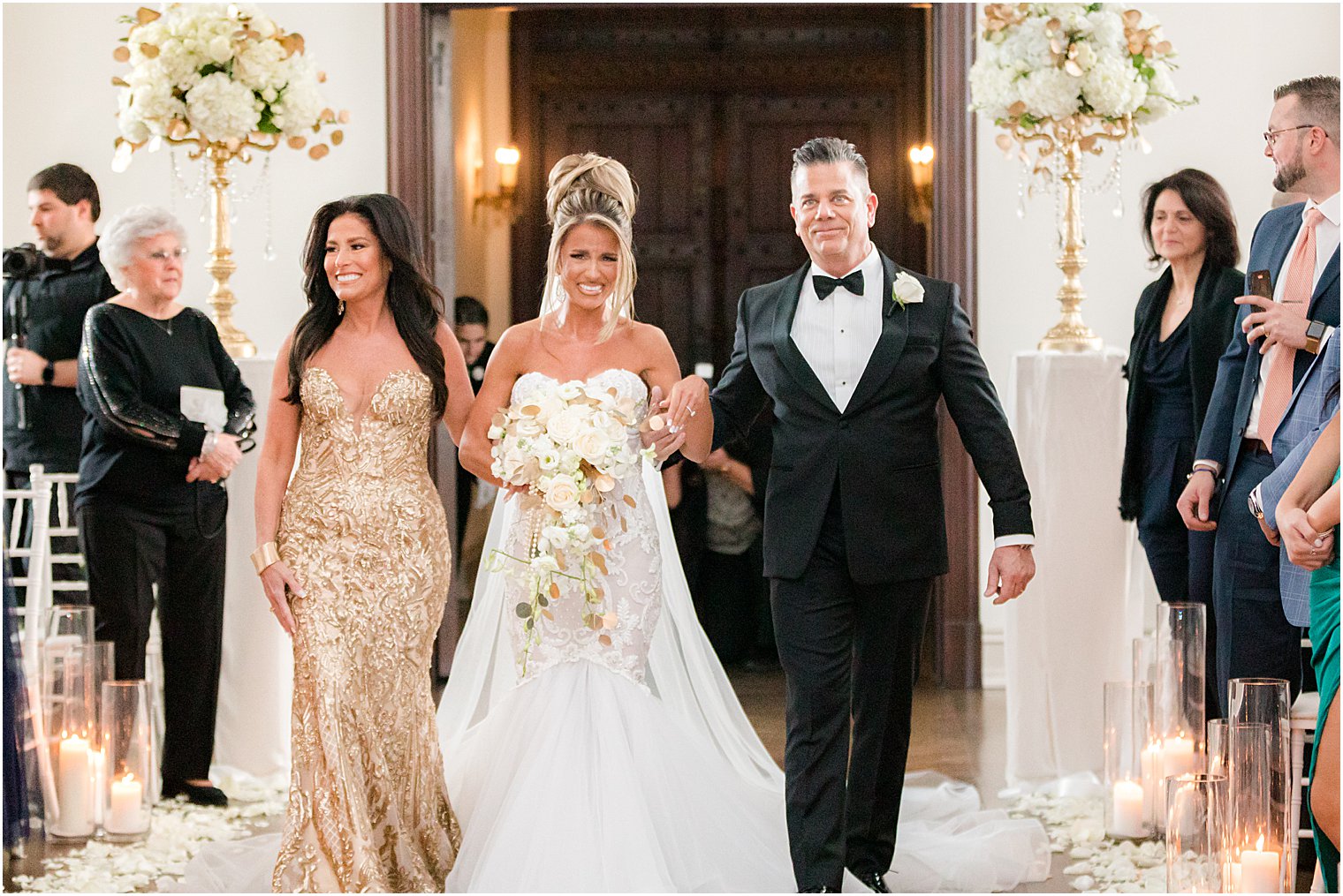 bride walks down the aisle crying during winter wedding ceremony 