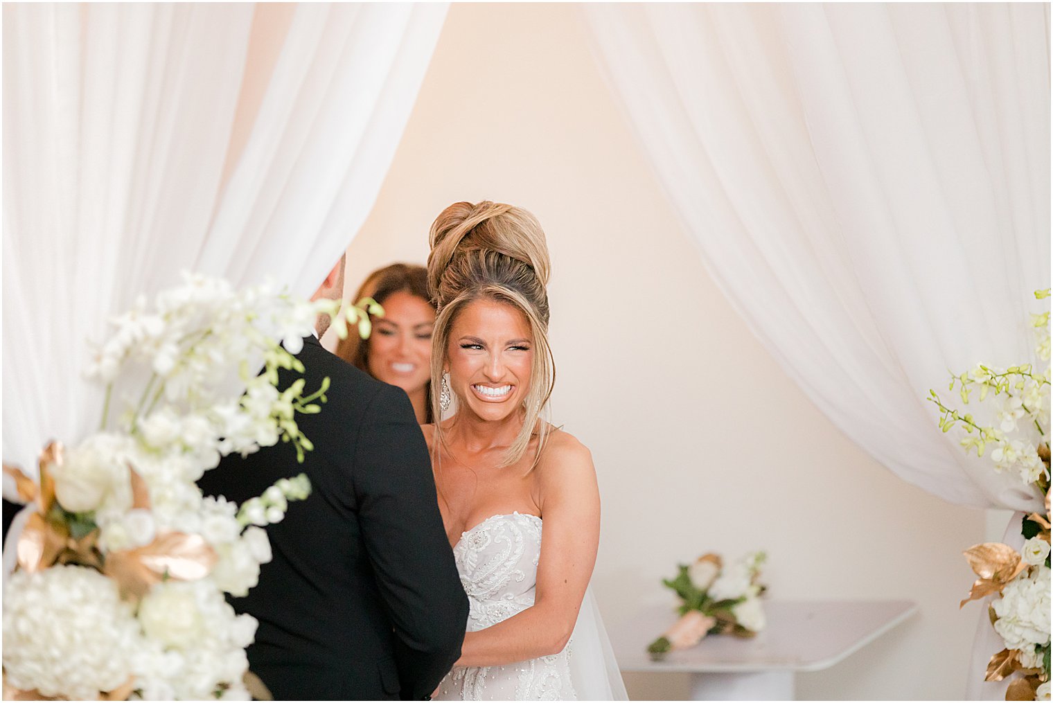 bride laughs during winter wedding ceremony at twilight in Park Chateau Estate chapel