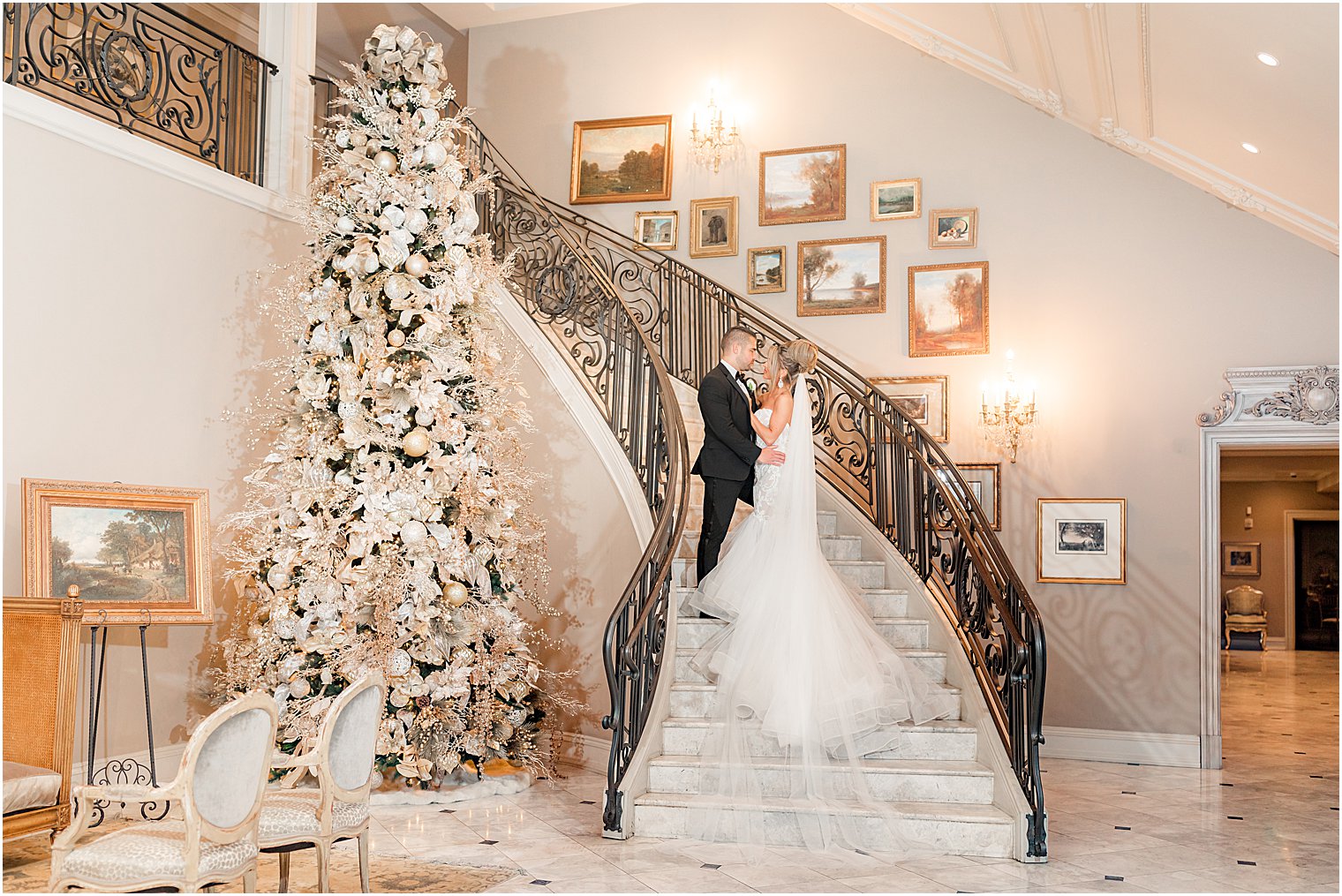 bride and groom hug on grand staircase at Park Chateau Estate