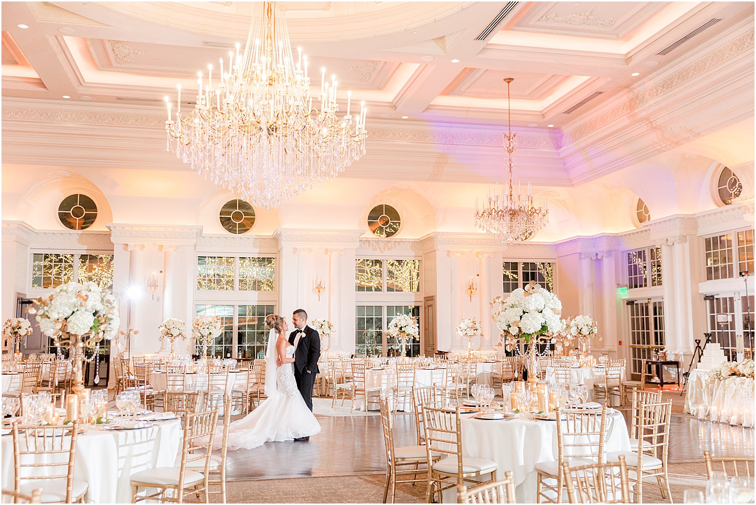 bride and groom hug in ballroom at Park Chateau Estate