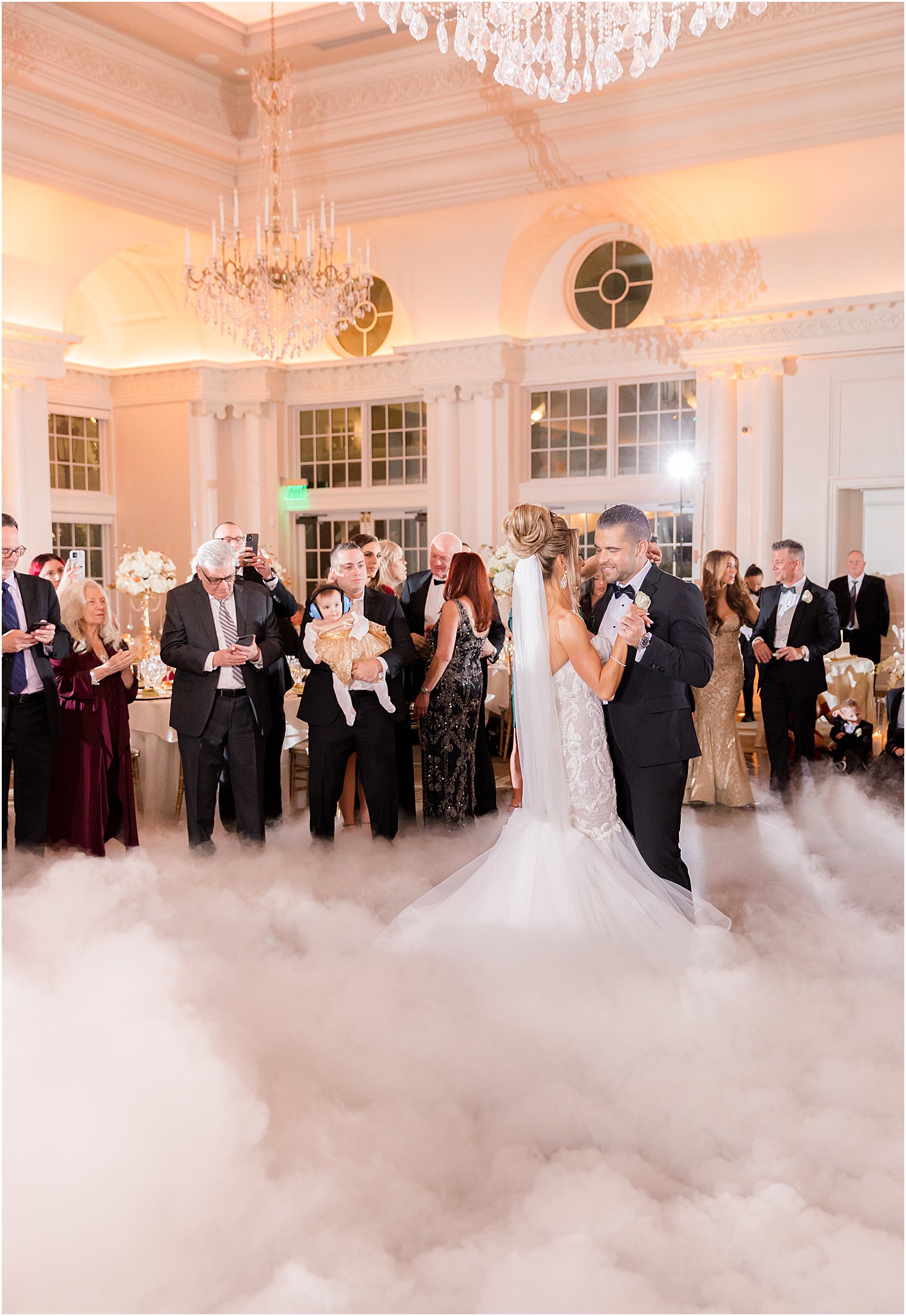 newlyweds dance with fog around legs in ballroom at East Brunswick NJ wedding reception
