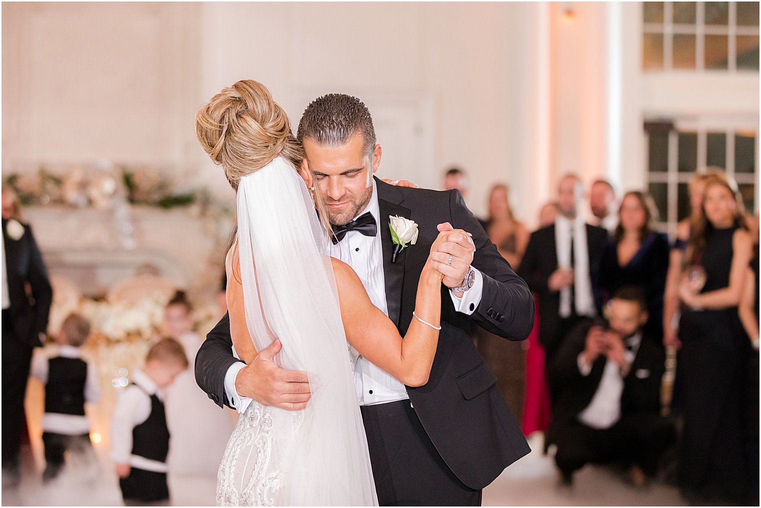 groom hugs bride close during first dance at East Brunswick NJ wedding reception