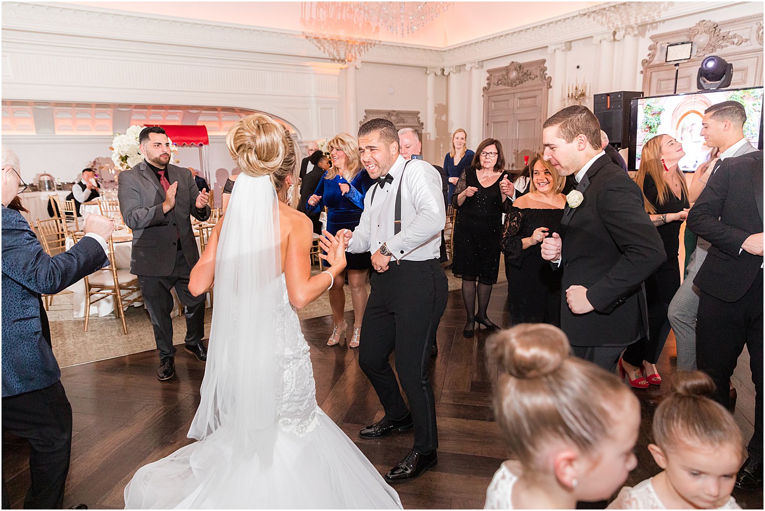 bride and groom dance with guests during East Brunswick NJ wedding reception