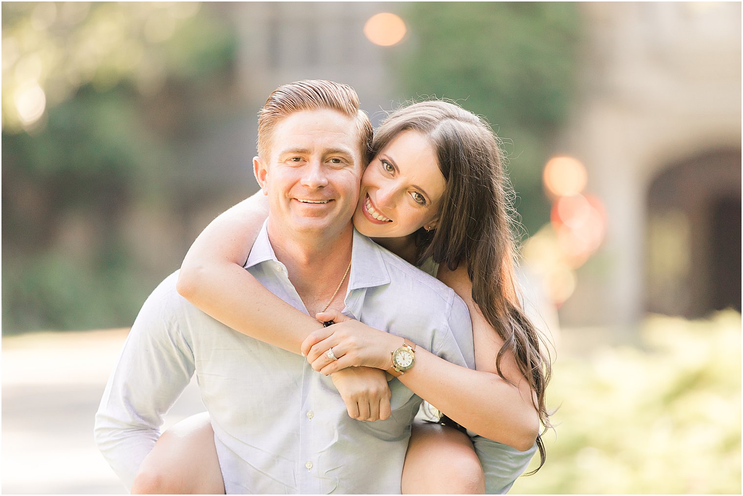 groom gives bride a piggy back ride during summer photos