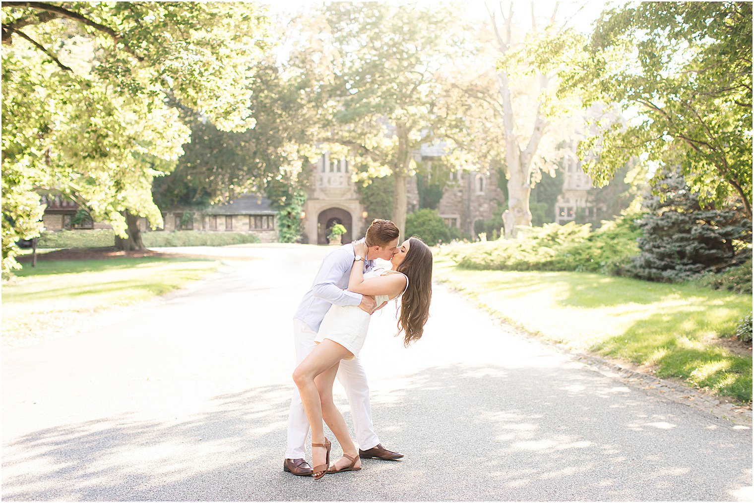 groom kisses bride dipping her during engagement photos