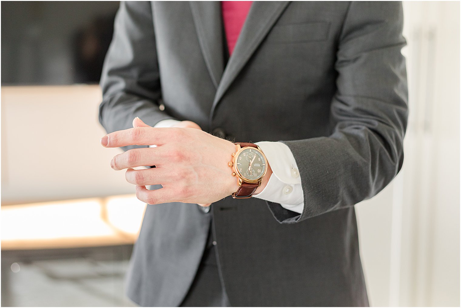 groom adjusts watch on wrist before NJ wedding